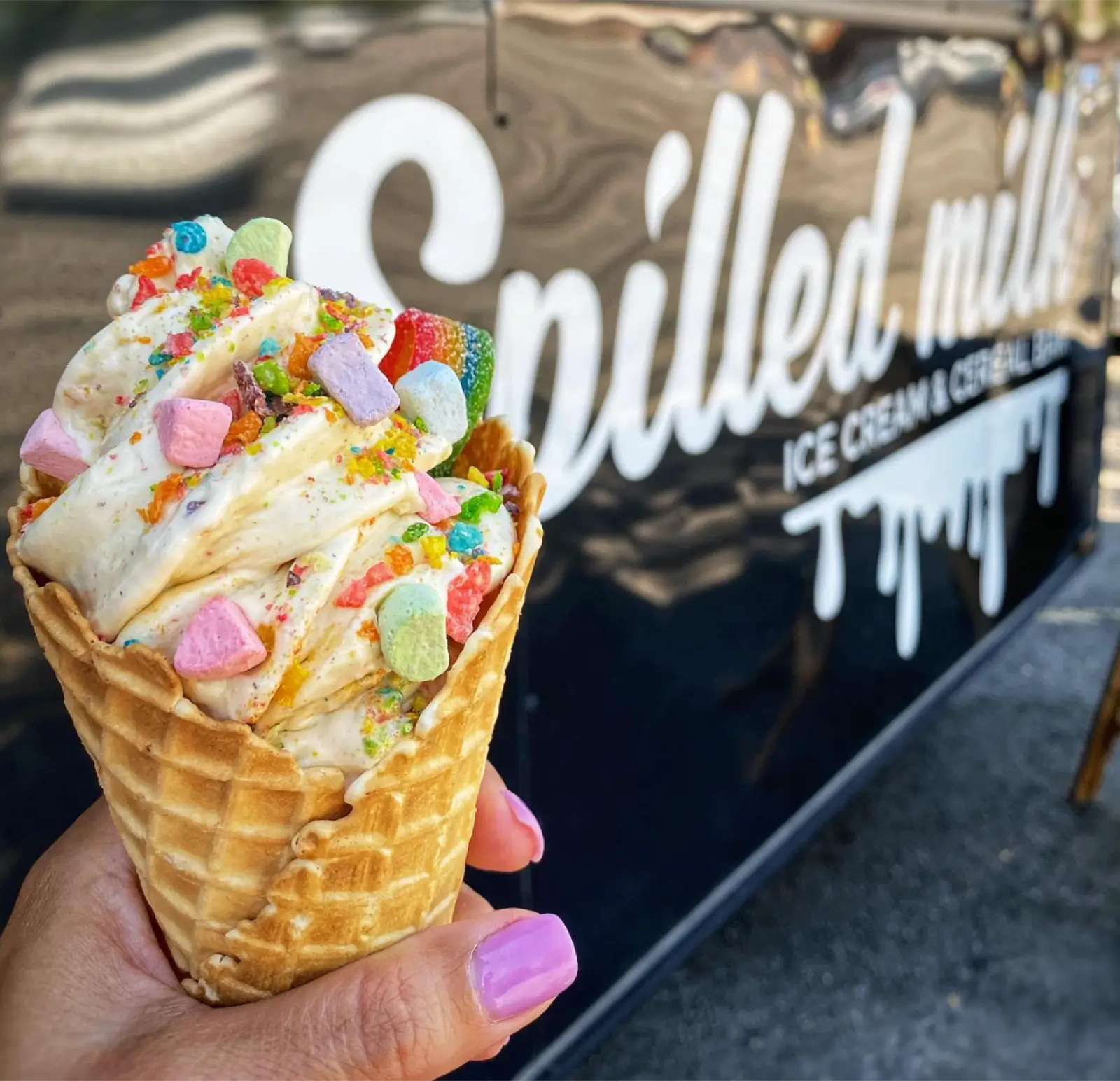 A Spilled Milk Over the Rainbow Cone outside of the Spilled Milk ice cream truck